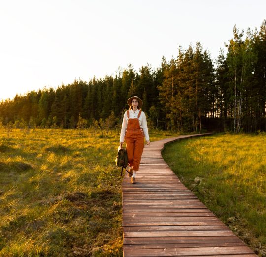 woman-naturalist-walking-on-path-through-peat-bog-2025-03-08-21-56-00-utc